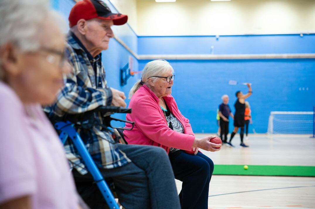 group of seniors smiling in community hall